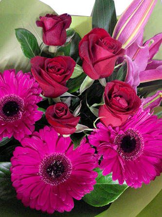 Flower bouquet of stunning pink gerberas, lilies and roses.
